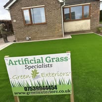 After 2 A house with a green artificial lawn and a sign for grass specialists.