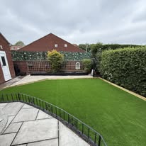 After 1 A well-maintained garden with artificial grass and a neatly trimmed hedge.